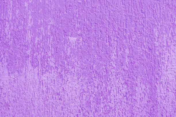 Textured purple wall with rich tones and subtle variations creating depth and visual interest in modern interior design.