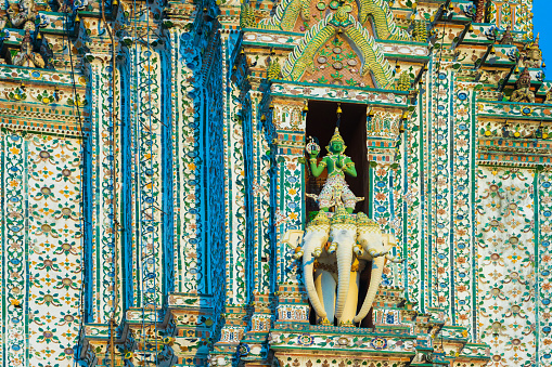 Detail of the Phra Prang, the central tower of the Wat Arun (Temple of Dawn) in Bangkok, Thailand, showing Indra on his three-headed elephant Erawan (Airavata). Encrusted with coloured faience