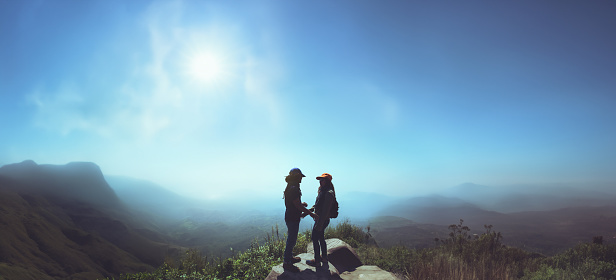 Lover woman and man asians travel relax in the holiday. Stand up landscape on the Moutain.