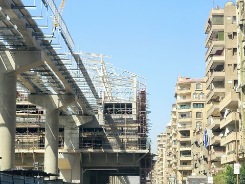 Cairo, Egypt, April 4 2024: A monorail station site that is under construction with scaffolds and crane, Cairo monorail is a two-line mono rail rapid transit system currently under construction, selective focus