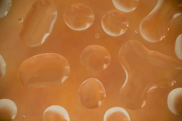 istock water beads pool on a glass surface lit from behind by and orange light 2138281326