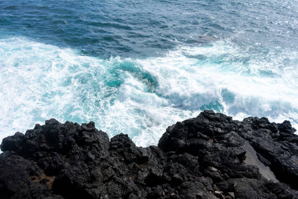 istock Sea crashing against volcanic black rocks . 2138283990
