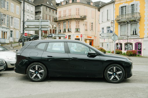 Oloron-Sainte-Marie, France - 25 March, 2024: A BMW iX electric car in a parking lot