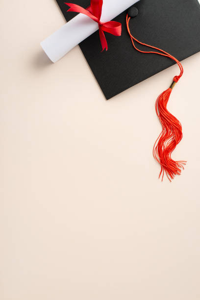 istock Celebrate success with a flat lay vertical top view composition showcasing mortarboard, and rolled diploma against a pastel background, offering space for your greeting text or marketing message 2138303937
