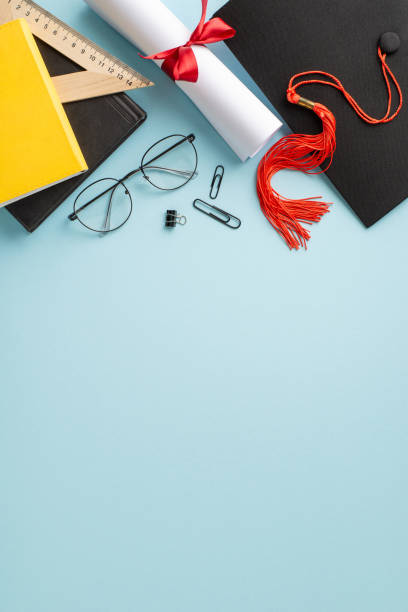 istock Capture the essence of achievement with a top view vertical composition showcasing mortarboard, diploma, learning tools, eyeglasses on a soft blue surface, offering space for your message or advert 2138303938