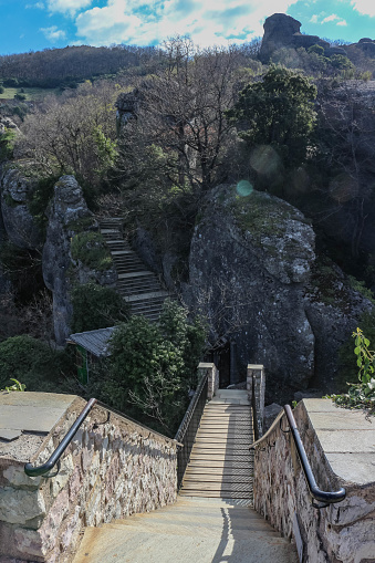 Embark on a magical journey as you ascend an enchanting stairway nestled amidst the breathtaking nature surrounding the ancient churches of Meteora, Greece