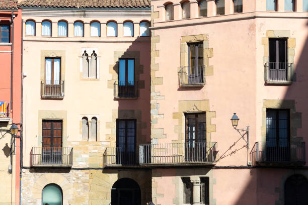 Traditional buildings with ornate facades under the clear blue sky in vic, spain