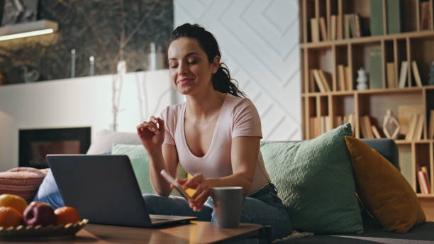 istock Girl freelancer rejoicing notification payroll on smartphone sitting living room 2138342955