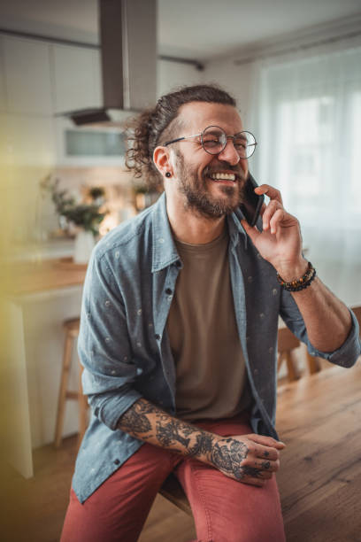 istock Happy man using mobile phone while in his apartment, surfing internet 2138373223