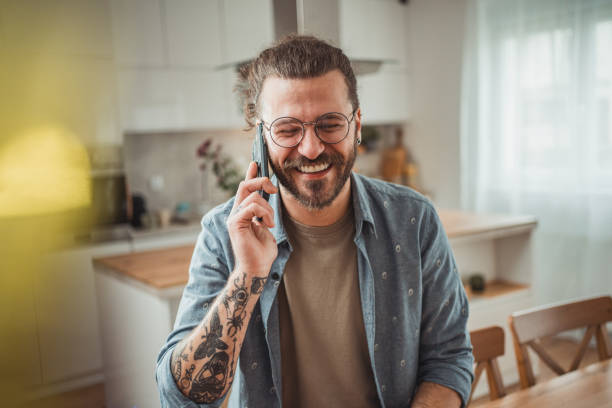 istock Happy man using mobile phone while in his apartment, surfing internet 2138374257