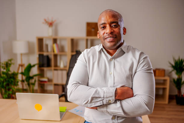 istock Smiling male CEO posing alone in modern office 2138395095