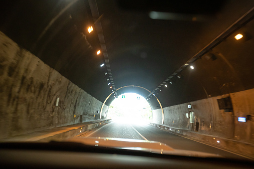 People driving car in tunnel