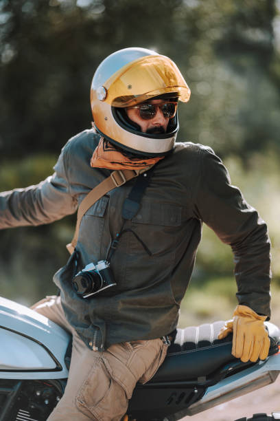 istock a man in a helmet on a motorcycle riding on a road 2138419028