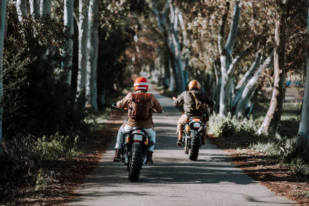istock two people on motorcycles traveling down a narrow path between trees 2138423906