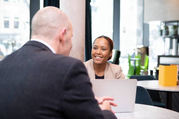 istock Cheerful business professionals working on a laptop in a cafe bar 2138428231