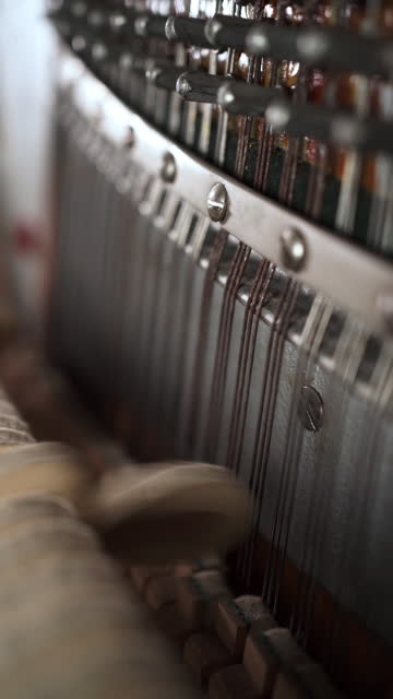 Close-up view of hammers strikes on strings inside piano