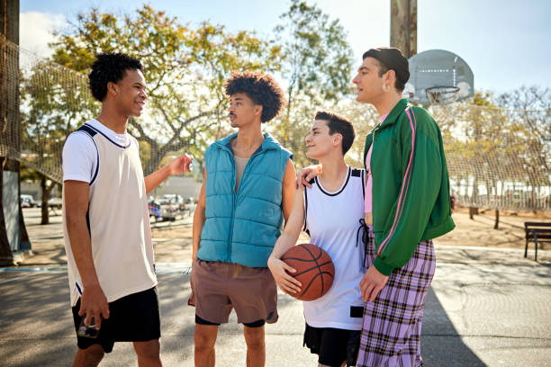 istock Friends standing and talking before basketball game 2138435135