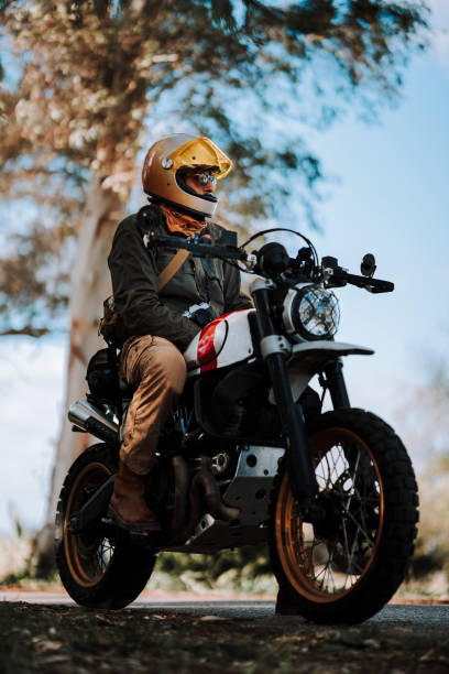 istock a man on a motorcycle wearing a yellow helmet and a black jacket 2138437798