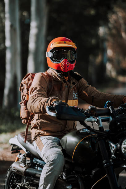 istock a man wearing a red helmet rides a motorcycle on a dirt road 2138437808