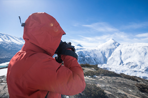Woman hiker hiking in winter hugh glacier mountain,China