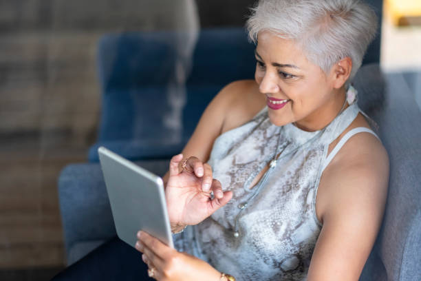 istock Mature woman working with technology from home 2138454542