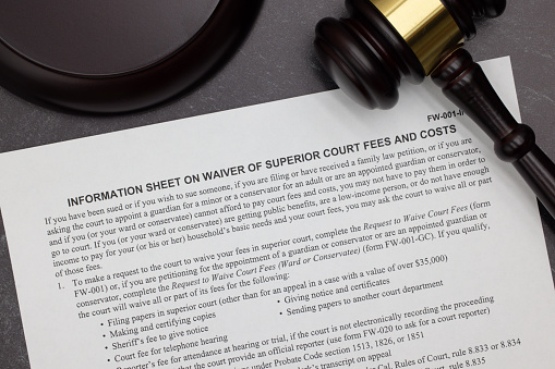 Superior Court Fee Waiver Information legal form with gavel and block on slate desktop