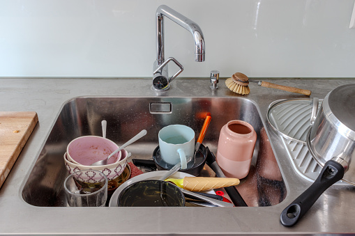 Dirty dishes in sink. Kitchen utensils need a wash