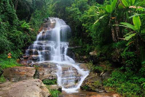 Slow motion shot of the Montha Than waterfall in the luxuriant jungle of the Doi Suthep national park, Thailand.
