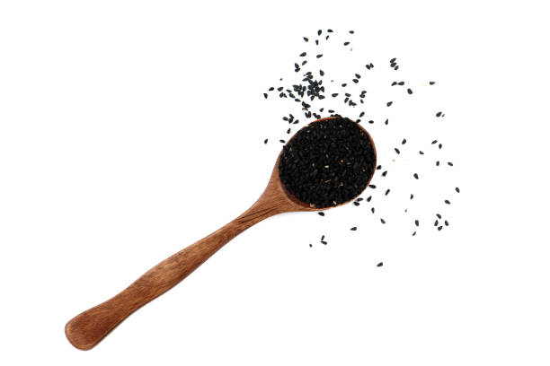 istock Top view black sesame seeds on spoon over white background. 2138517080