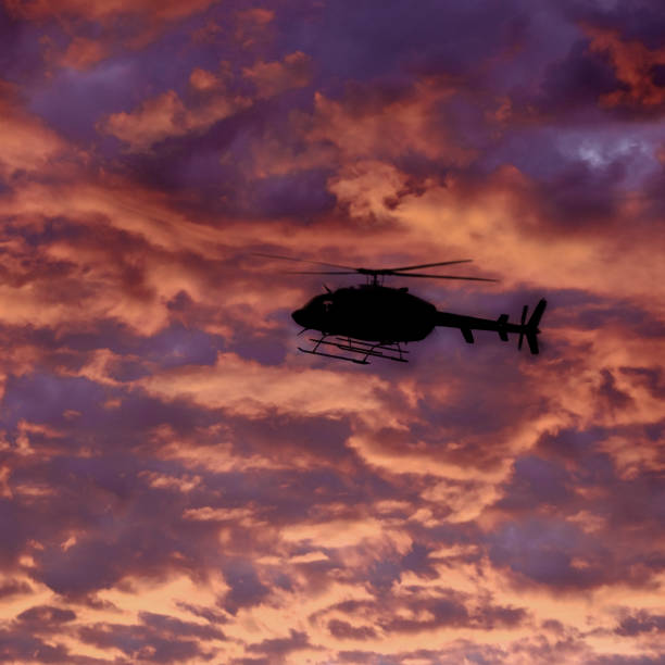 istock Helecopter Flying at Sunset or Sunrise in Sky Dramatic Clouds with Mountains 2138530773