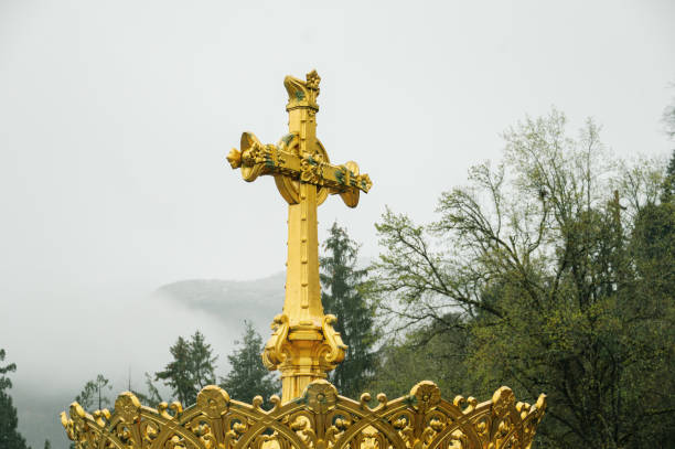 A golden Christian Cross on top of a dome
