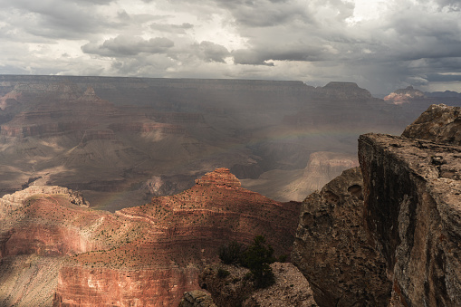 Panoramic photo of Grand Canyon in Arizona with rainbow and cloud