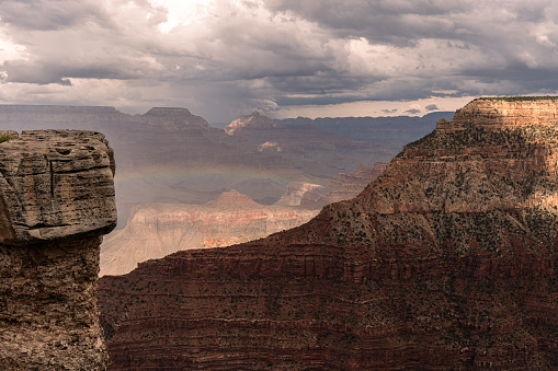 Panoramic photo of Grand Canyon in Arizona with rainbow and cloud