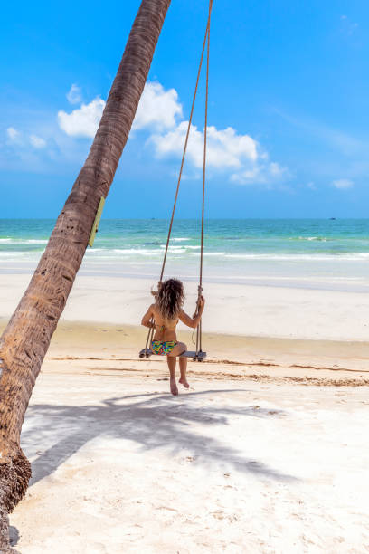 istock An attractive woman enjoys a swing 2138547735