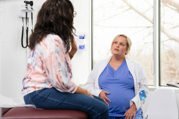 istock Pregnant doctor listens carefully to unrecognizable patient 2138564492