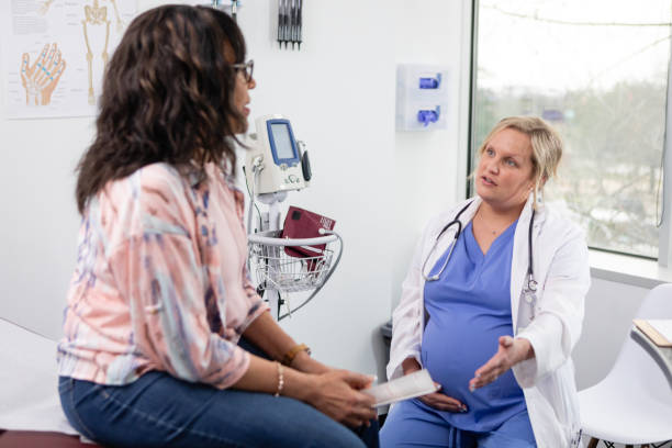 istock Pregnant doctor discusses female patient's concerns 2138565047