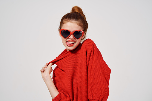 fashion woman in red sweater gesturing with her hands thumb model. High quality photo
