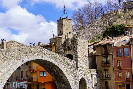 Girona, Spain - March 29, 2024. The river Ter passes through the medieval village of Camprodon with its ancient stone bridge. Girona, Spain