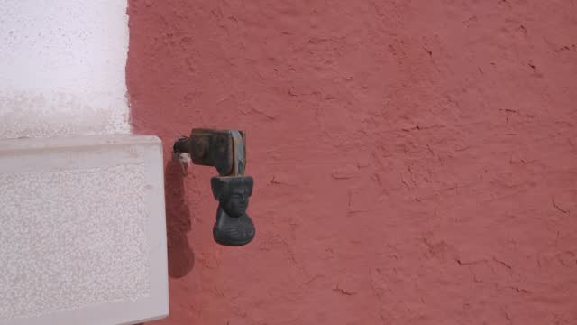 Antique wall-mounted spout in Burano