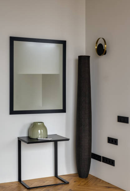 istock A wooden table with a mirror on the wall in a room with hardwood flooring 2138613708