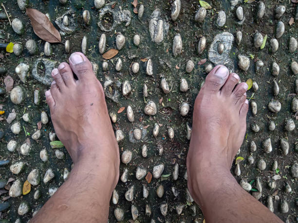 two feet are reflecting on small stones. selective focus