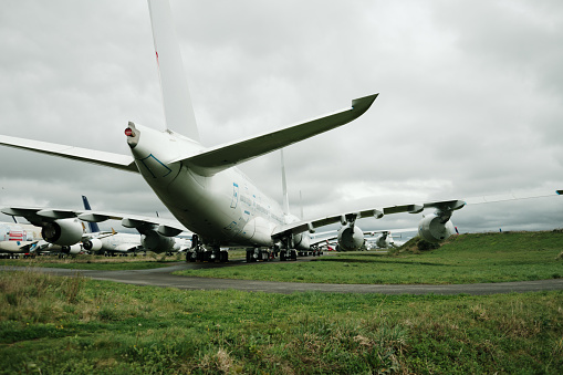 Large obsolete passenger airplanes in a dismantling and recycling facility