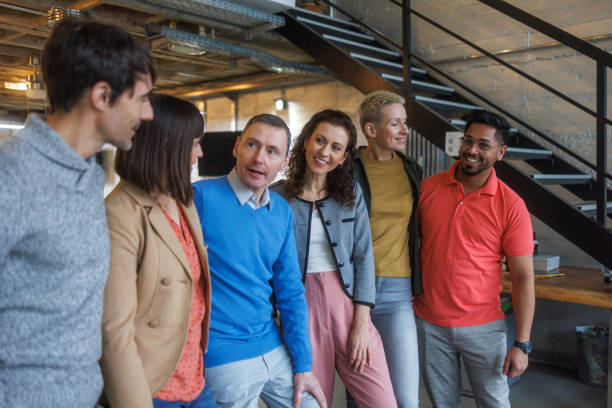 Six people standing in the office and smiling