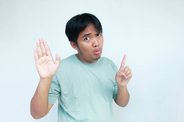 istock A young Asian man looking unhappy and angry showing rejection. 2138656590