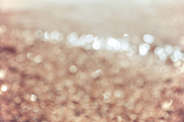 Summer is here. Happy Sunny Blur Photo. Picture of the sandy beach as abstract bokeh background. Beige colors. Closeup. Feel good vintage style.