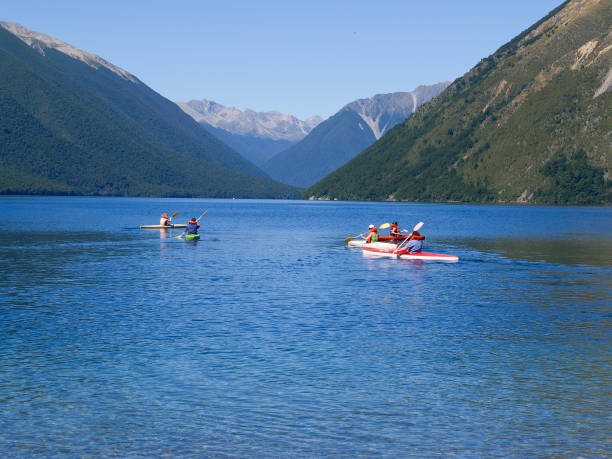 Lake Roto-iti New Zealand - February 17 2007; Mountains backdrop to on water activity on sunny day on Lake Roto-iti