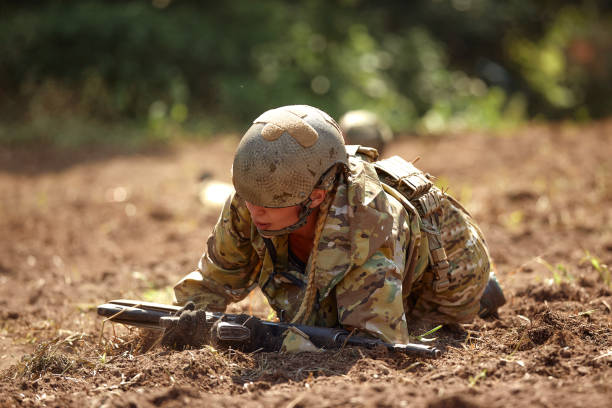 istock Full military experience - One day commando - running through the water with automatic rifle replica 2138682785