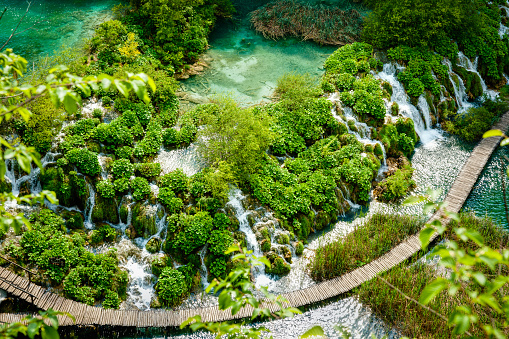 Birds eye view of wooden boardwalk through waterfalls and ponds of Plitvice Lakes National Park Croatia