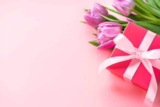 istock Mother's Day gift box and tulips on pink background. Copy space 2138703701