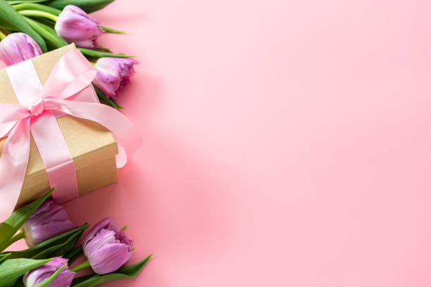 istock Mother's Day concept. Brown gift box and tulips on pink background. Copy space 2138703705